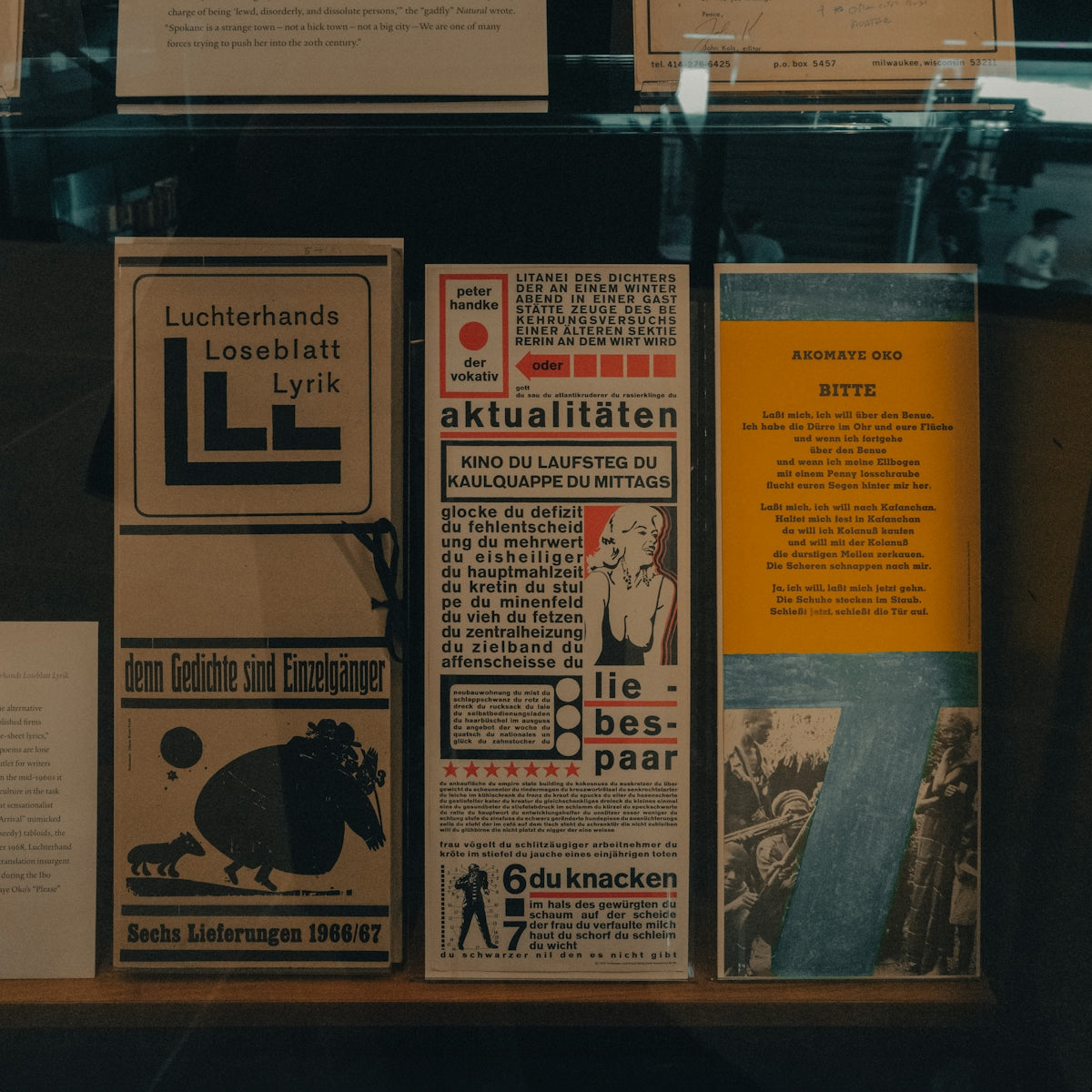 Three vintage german posters displayed in a museum